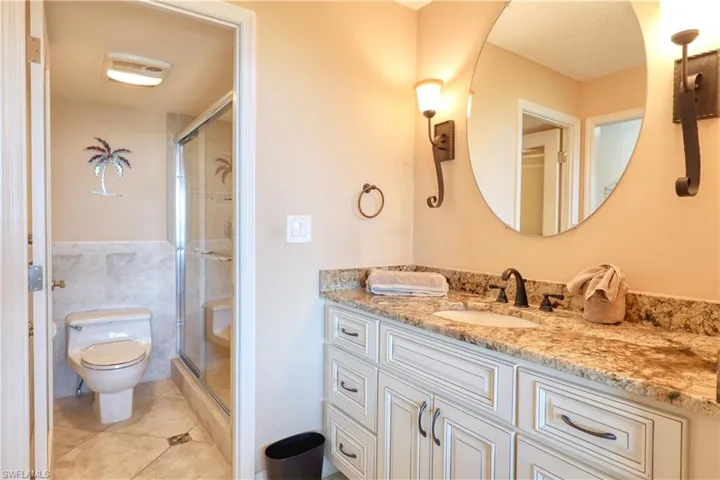 Bathroom with vanity, a shower stall, and light tile patterned floors