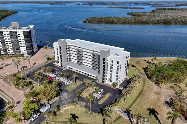 Aerial view of apartment complex / building and a nearby body of water
