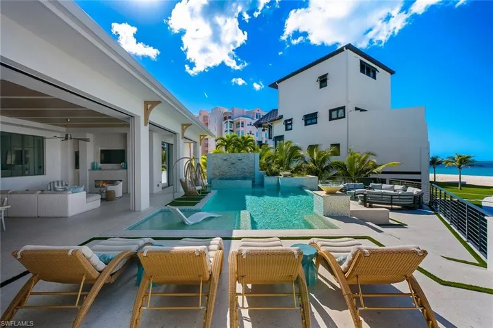 Swimming pool with an outdoor living space and a patio area