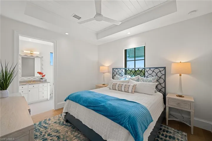 Bedroom with recessed lighting, a ceiling fan, light wood-type flooring, a raised ceiling, and wooden ceiling
