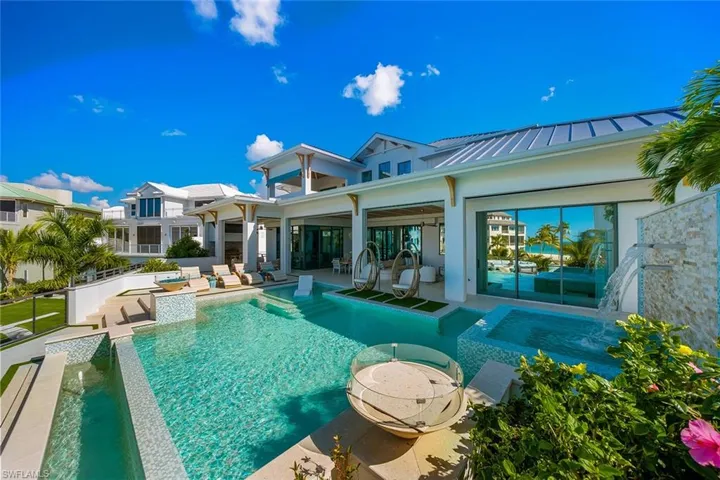 Swimming pool with a patio and an in-ground hot tub