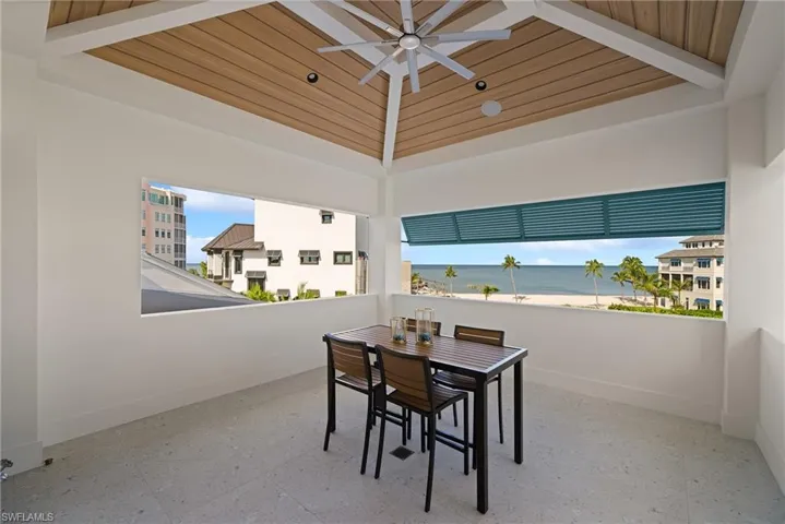 View of patio / terrace featuring outdoor dining area, ceiling fan, and a water view