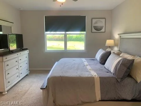 Bedroom featuring light carpet and ceiling fan