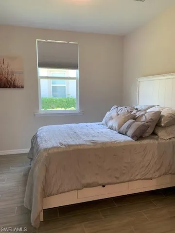 Bedroom with hardwood / wood-style flooring