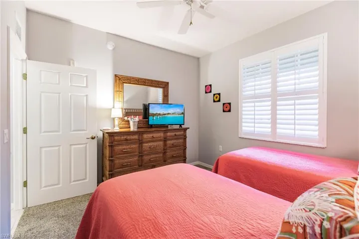 Carpeted bedroom with ceiling fan