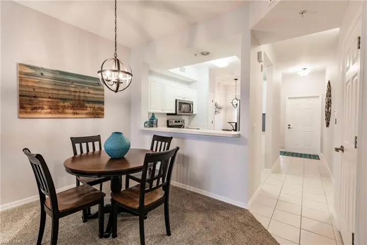 Dining room featuring light tile floors and an inviting chandelier