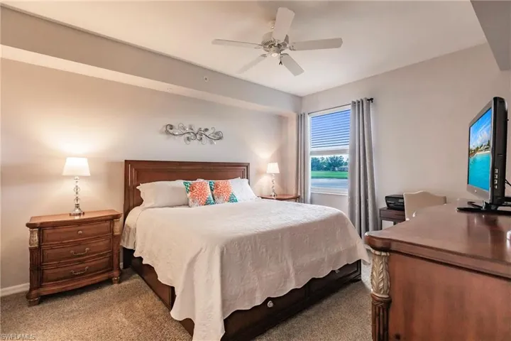 Bedroom featuring ceiling fan and carpet floors