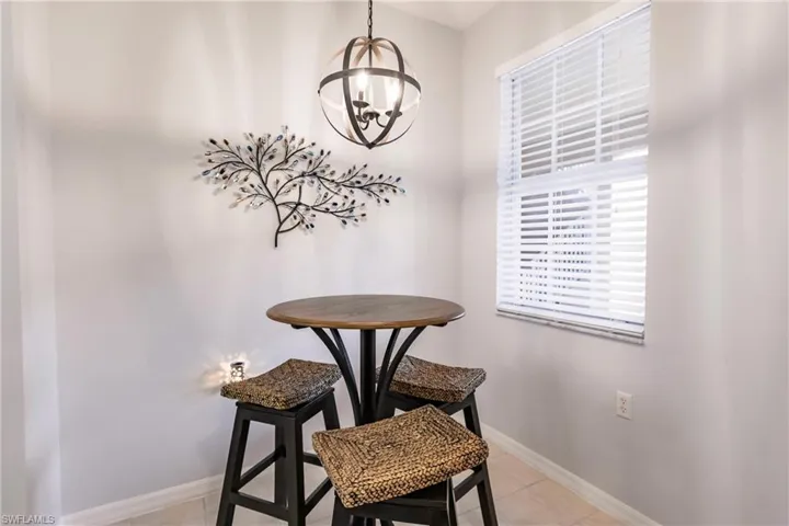 Dining space with an inviting chandelier and light tile floors