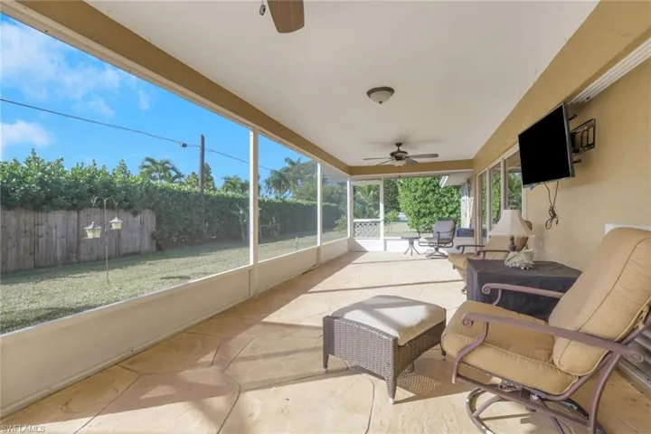 Sunroom featuring a ceiling fan
