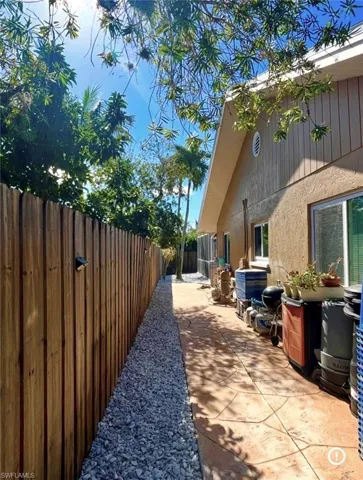 View of side of property with a fenced backyard and a patio area