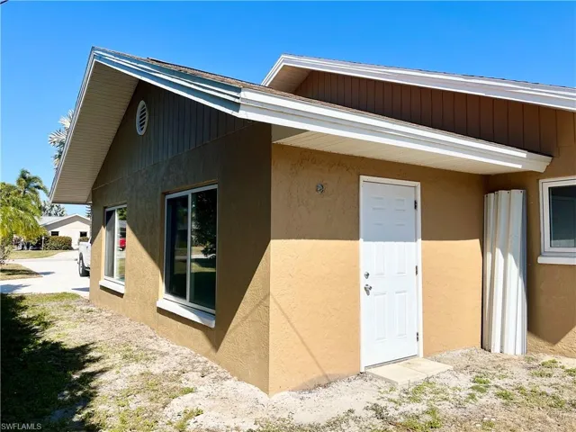 Entrance to property featuring stucco siding