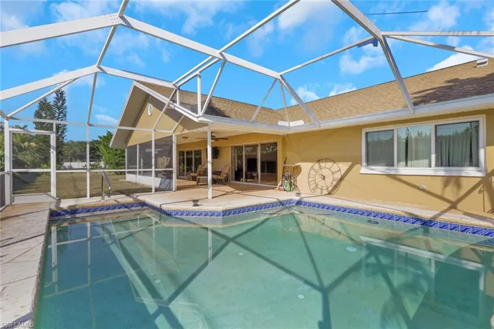 Outdoor pool with a sunroom, a lanai, and a patio area