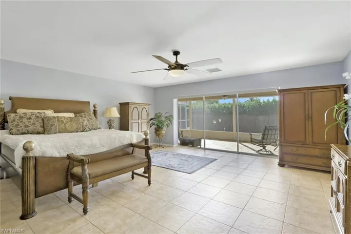 Bedroom with access to exterior, ceiling fan, and light tile patterned floors