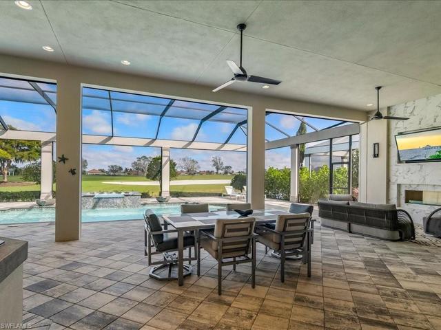 covered lanai space complete with summer kitchen, dining, and sitting area