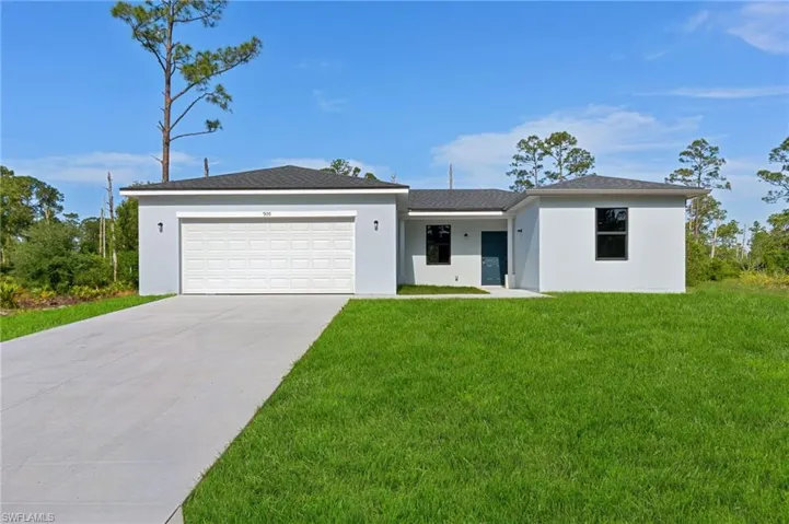 Ranch-style house featuring concrete driveway, an attached garage, stucco siding, and a front yard
