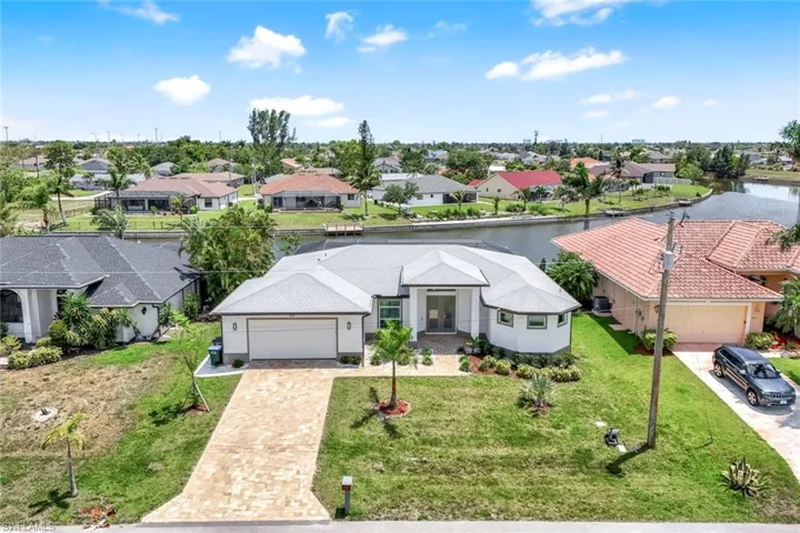 Aerial perspective home with canal/intersection water view
