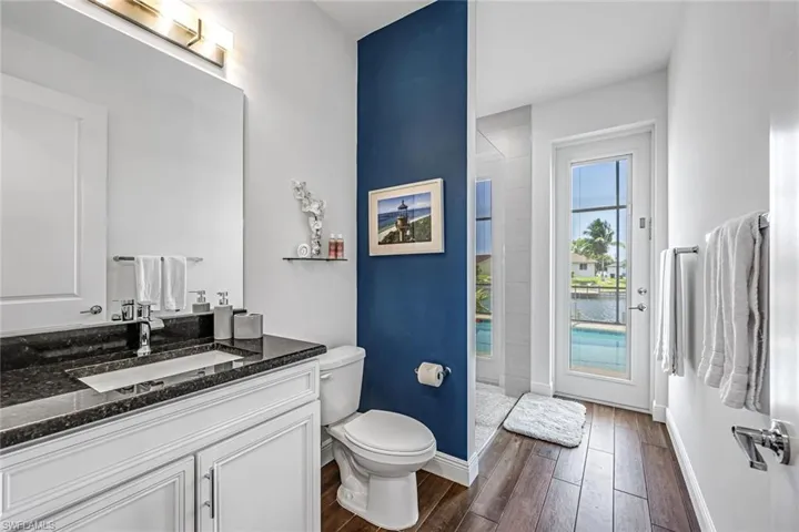 Bathroom, tiled shower, toilet, vanity, pool access