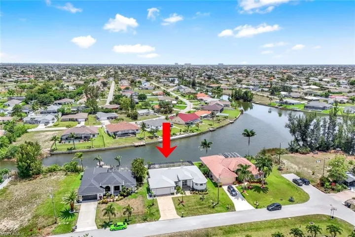 Aerial view of property and surrounding area with nearby suburban area and a nearby body of water