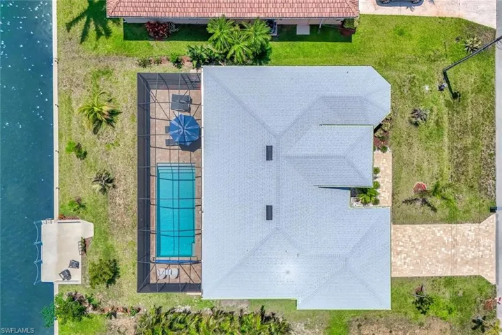 Aerial view of property and surrounding area with a pool