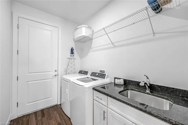 Washroom with separate washer and dryer, and sink with granite top