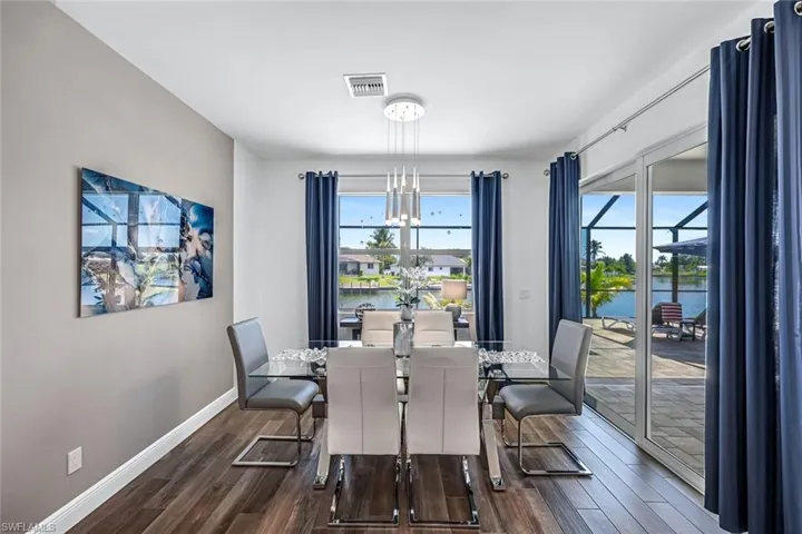 Dining area next to kitchen sliding doors to the pool