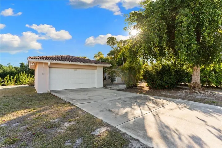 Garage featuring concrete driveway