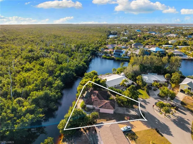 Aerial perspective of suburban area featuring property parcel outlined and a large body of water