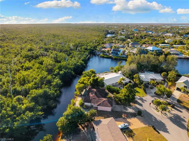 Aerial overview of property's location with nearby suburban area and a nearby body of water