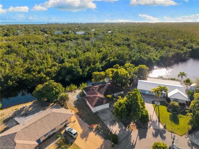 Aerial view of a nearby body of water and a heavily wooded area