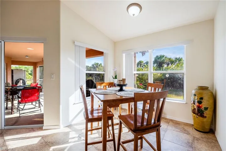 Dining room with vaulted ceiling and baseboards