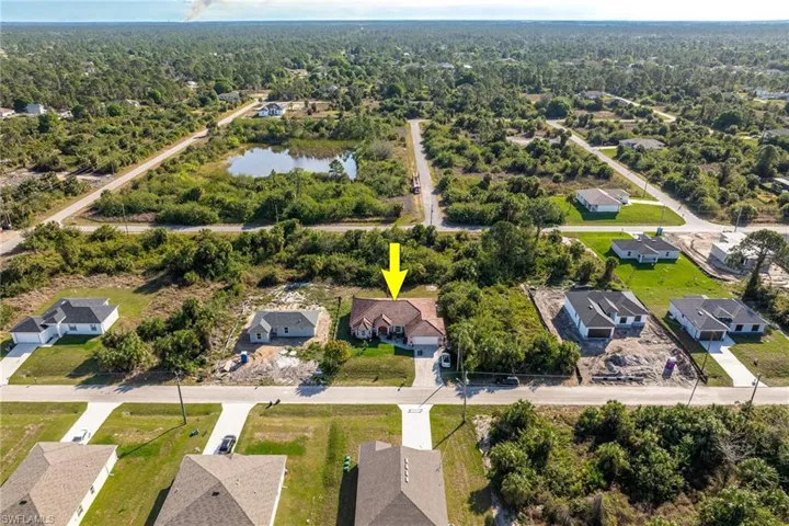 Drone / aerial view with a water view and a residential view