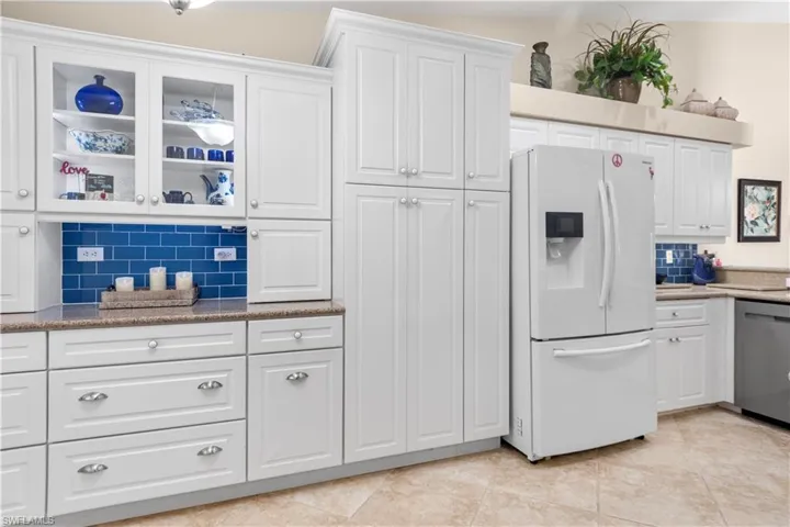 Kitchen with custom coffee bar, Quartz counters, soft-close cabinets & drawers. French Door Refrigerator.