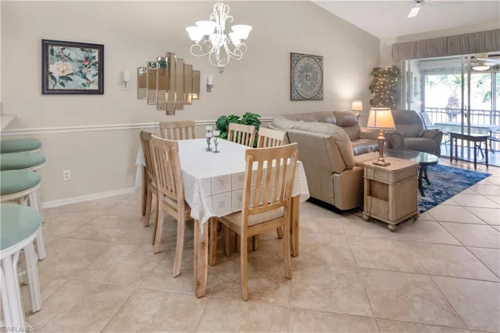 Tiled dining room with vaulted ceiling