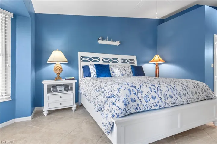 The primary ensuite is in the back of the home with a slider leading to the lanai.
