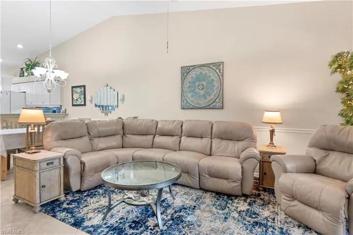 Tiled living room featuring vaulted ceilings