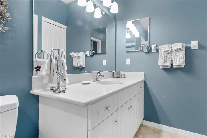 Primary bathroom with quartz vanity.