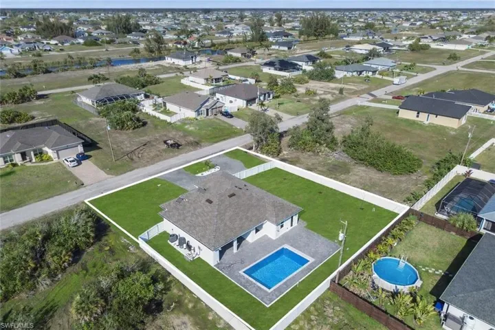Aerial perspective of suburban area with a pool area