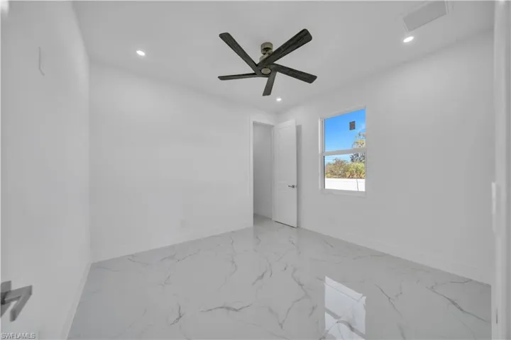 Spare room with recessed lighting, light marble finish flooring, and a ceiling fan