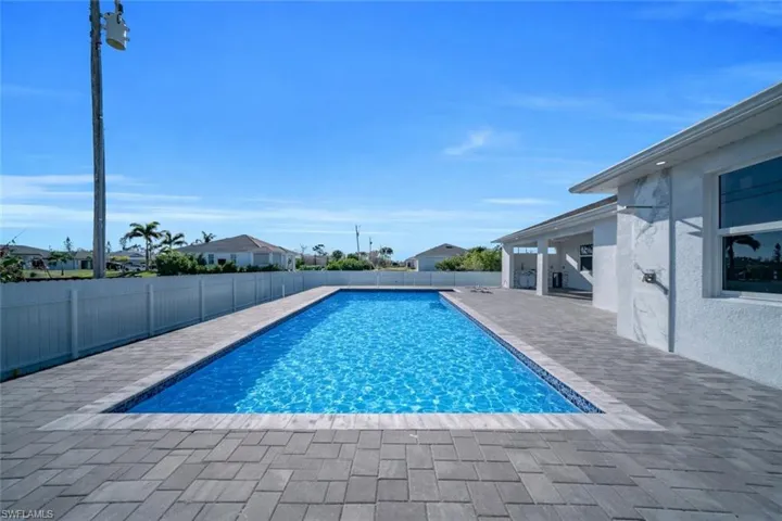 View of pool with a fenced backyard and patio surround