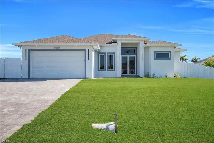 Prairie-style home with french doors, a garage, decorative driveway, stucco siding, and a shingled roof