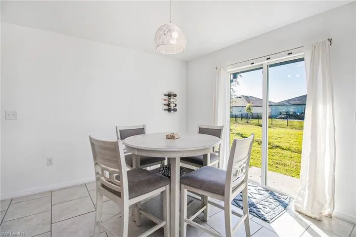Dining space featuring baseboards and light tile patterned floors