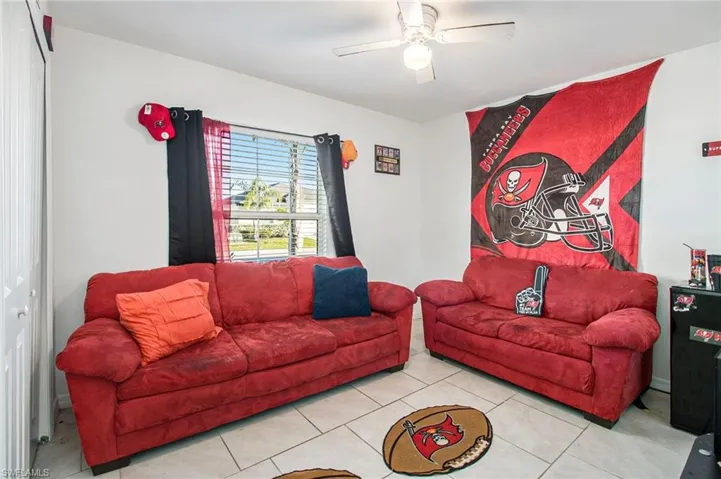 Tiled living area with a ceiling fan