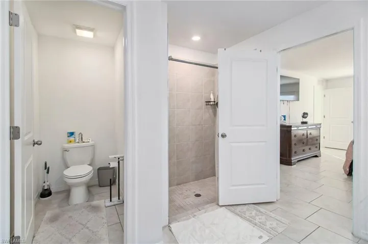Bathroom featuring a stall shower and light tile patterned flooring