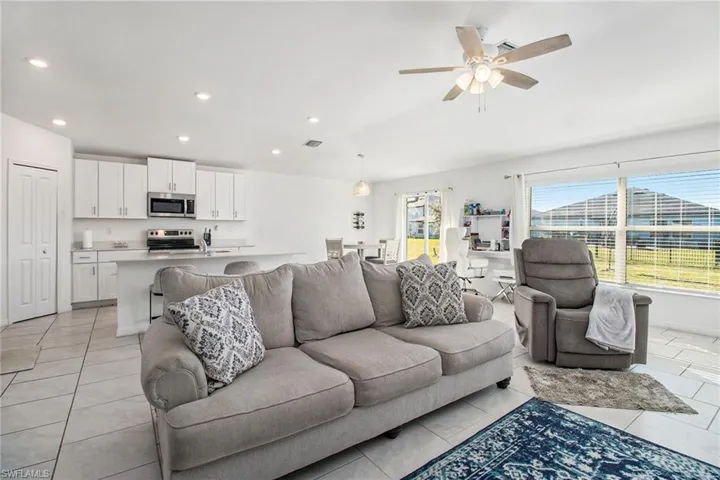 Living area featuring recessed lighting, ceiling fan, and light tile patterned flooring