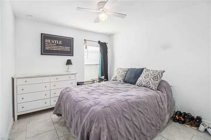 Bedroom featuring light tile patterned floors and ceiling fan