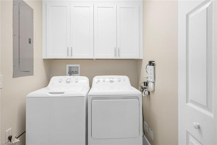 LAUNDRY WITH CABINETS AND NEW WASHER/DRYER
