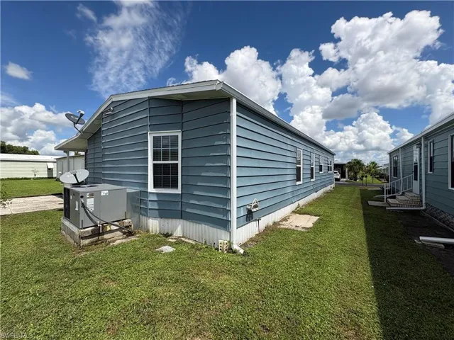 View of property exterior featuring a yard