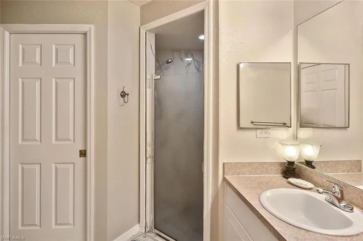 Master Bathroom with a shower stall, and double vanity