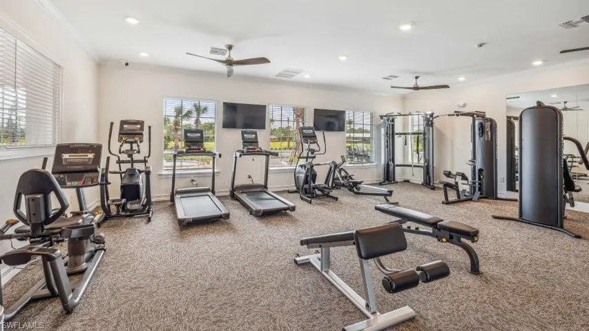 The property features a well-equipped fitness center with cardio machines, weight trainingequipment, and reflective wall panels