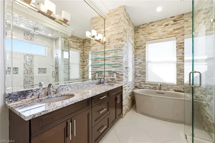 Main bedroom bath with soaking tub, dual sinks, floating shelves and upgraded shower